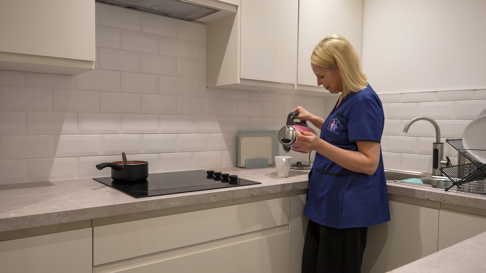 A carer preparing tea in a client's kitchen