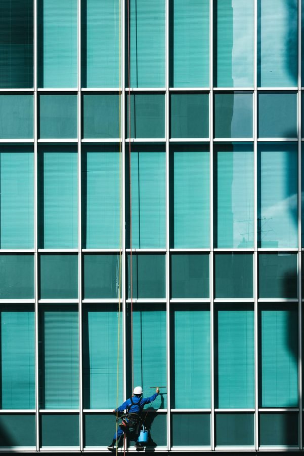 A window cleaner working on a commercial building